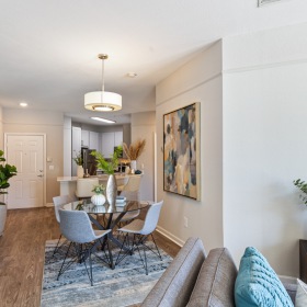 View of dining room and kitchen in an apartment home at The Savoy at Southwood View of dining room and kitchen in an apartment home at The Savoy at Southwood