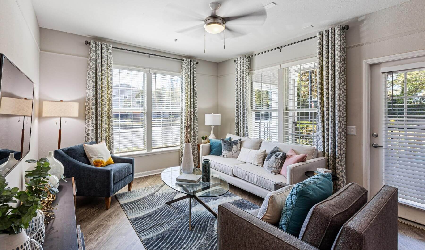 Apartment living room with large windows at The Savoy at Southwood